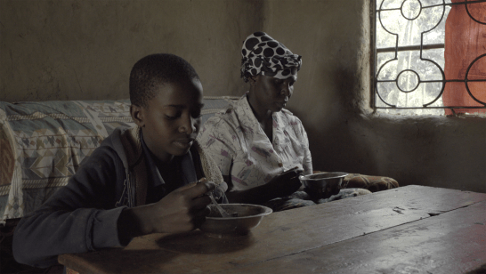 Joshua and his grandmother eating breakfast.